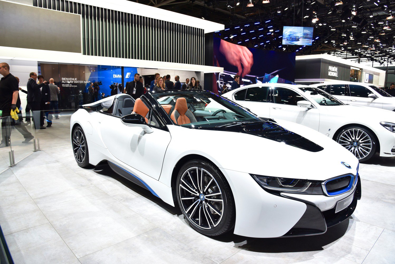 Convertible sports coupe with sleek white body and luxury brown interior.