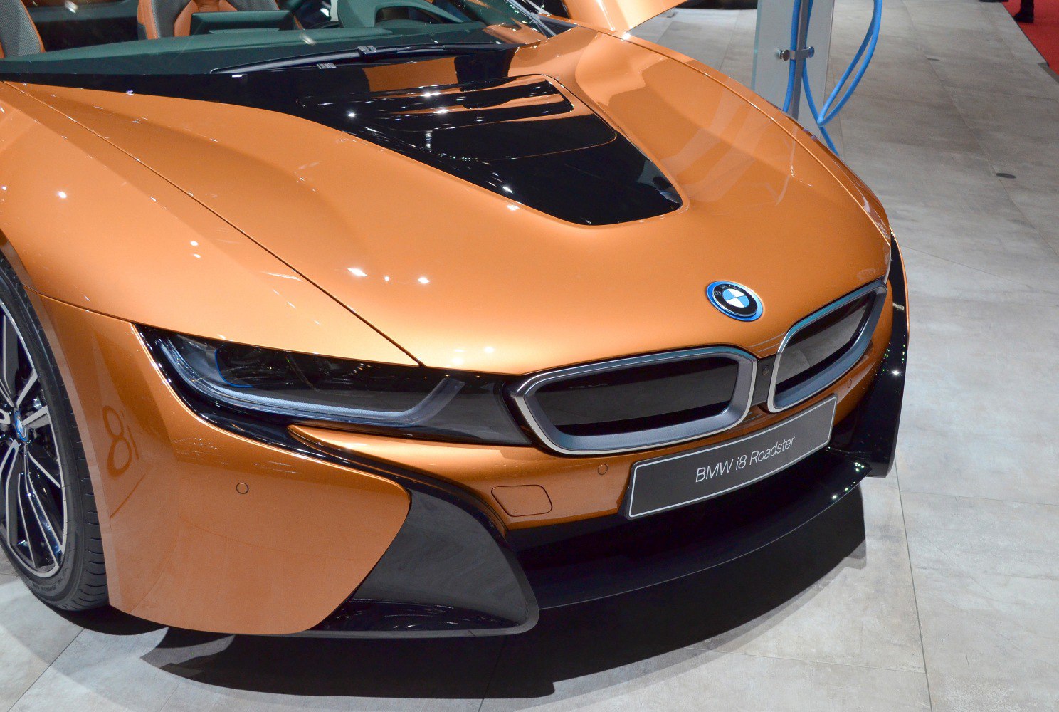Close-up of sports car front end with sleek hood and LED headlights