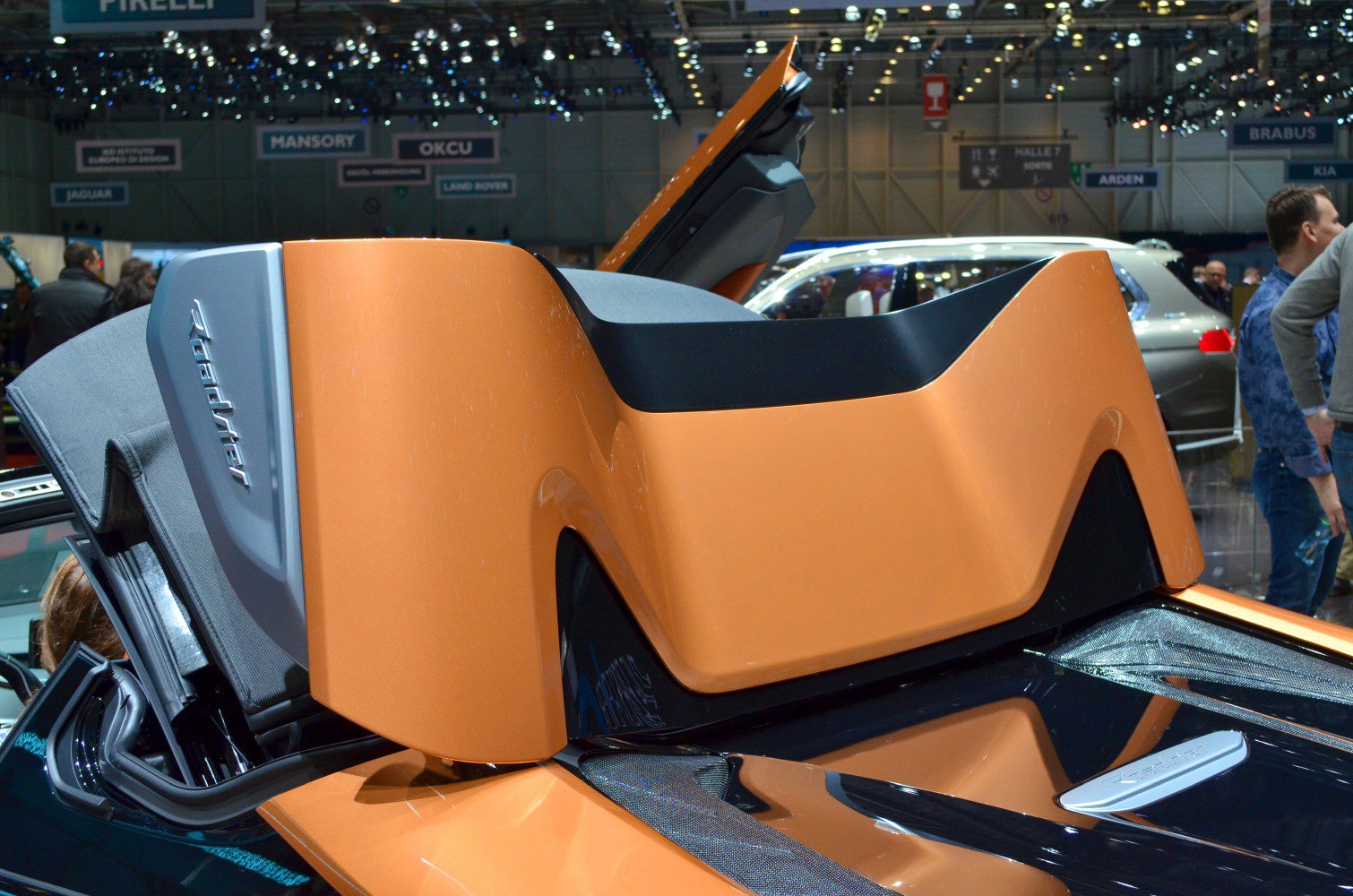 Butterfly doors open on a sporty hybrid roadster rear end.
