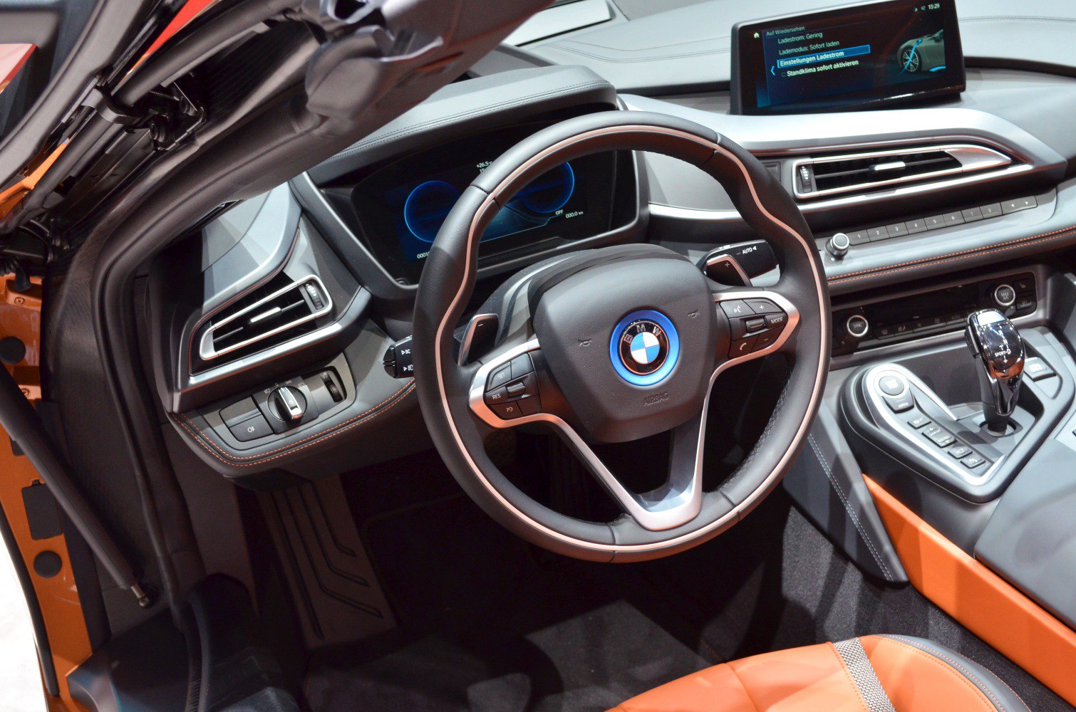 Digital dashboard and modern car interior with steering wheel and center console.