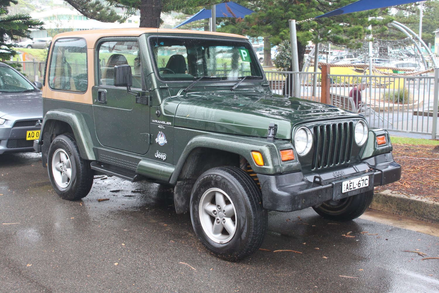 Soft top SUV front side view with round headlights and rugged wheels