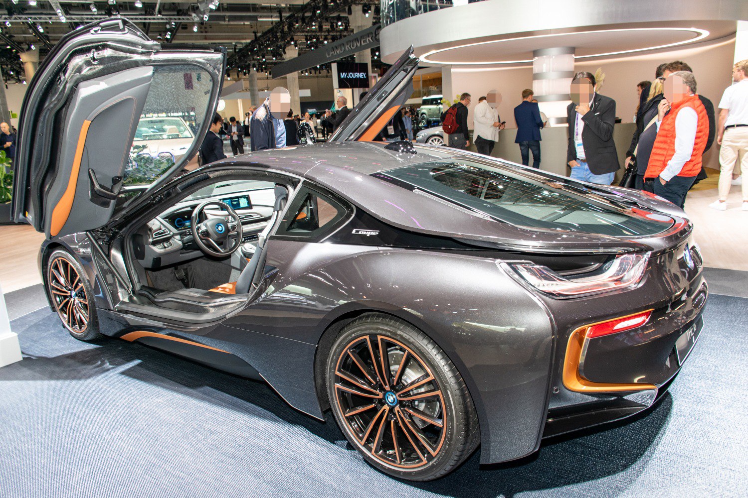Gullwing doors and aerodynamic rear spoiler on a sleek sports coupe