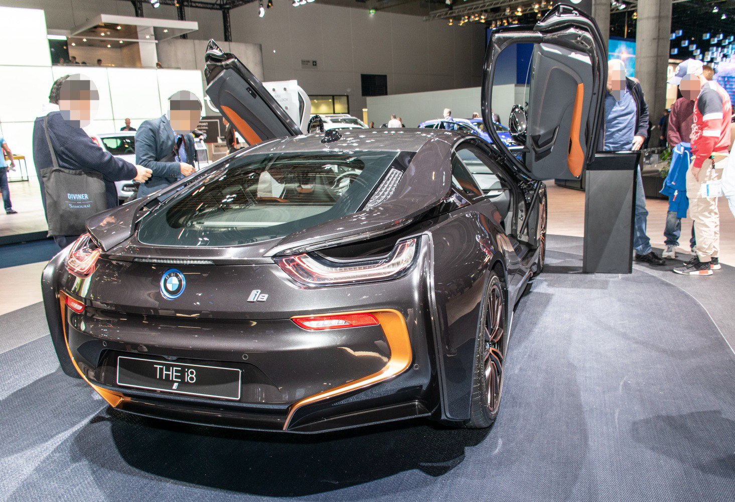Rear view of sports coupe with open butterfly doors and distinctive taillights