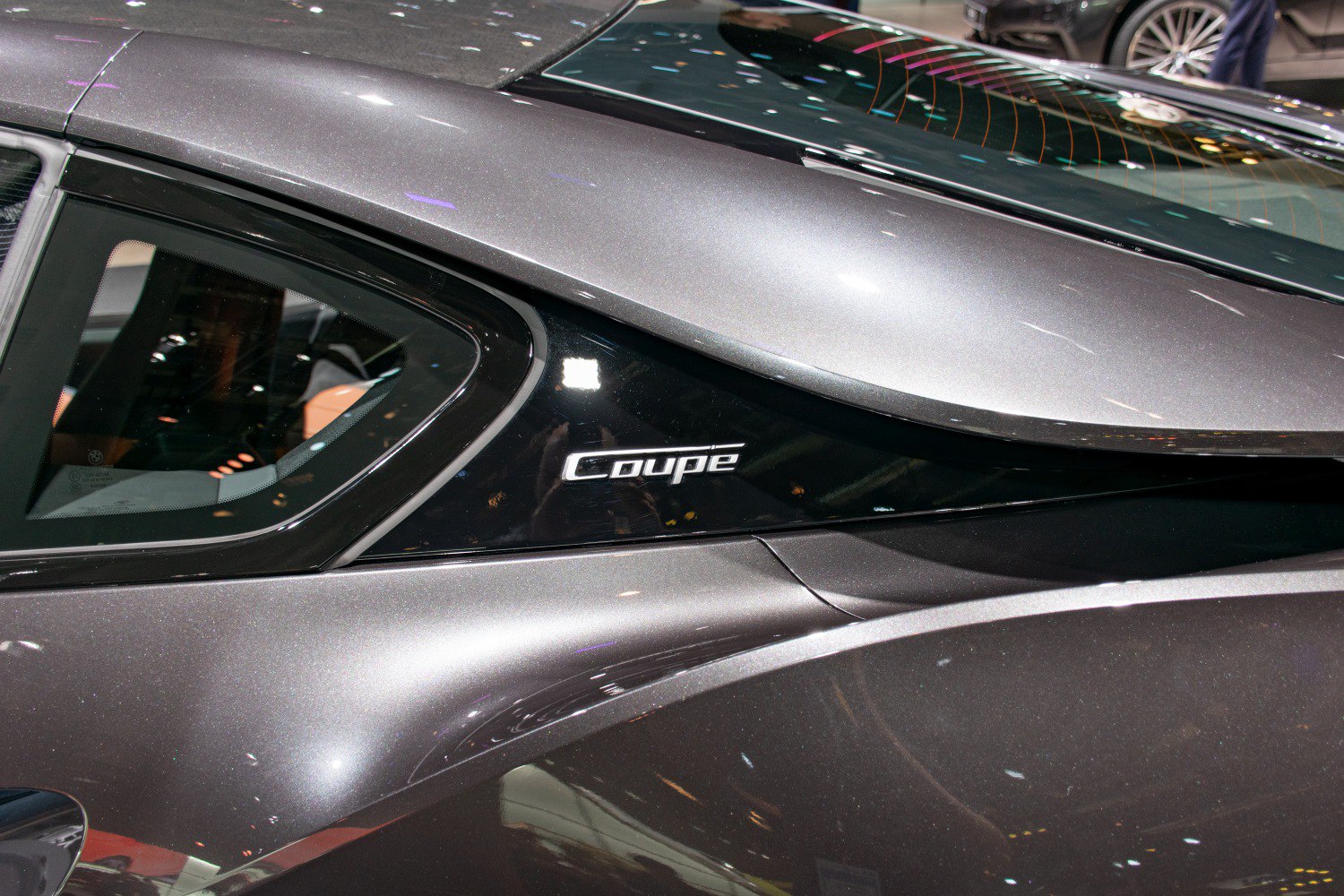 Side panel with Coupe emblem and sleek rear window detail