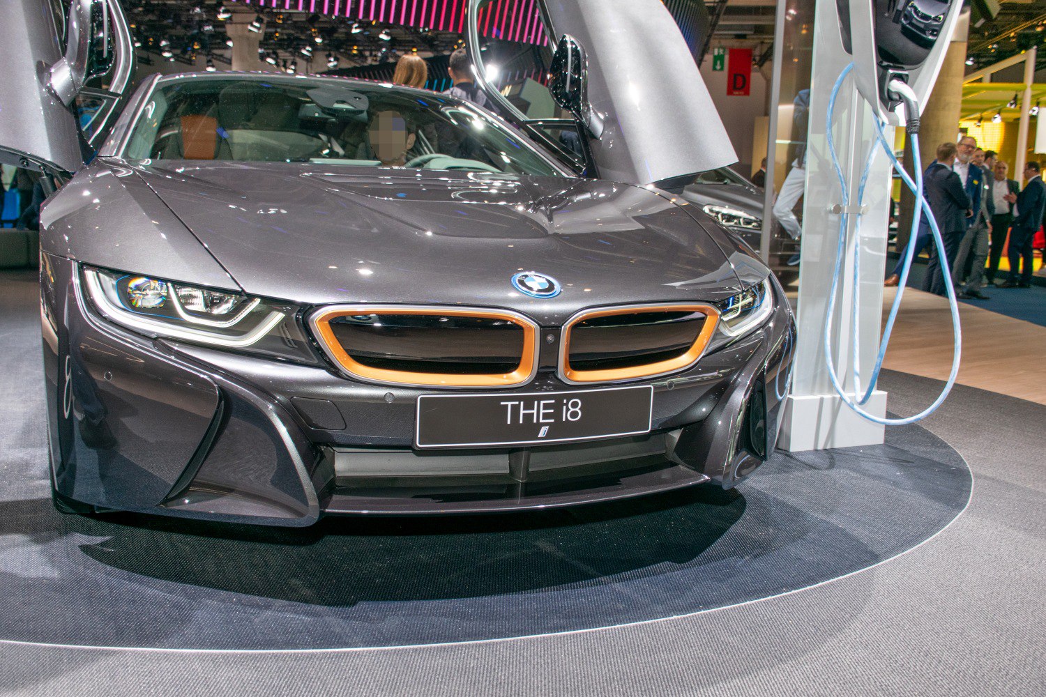 Front view with open scissor doors and highlighted kidney grille