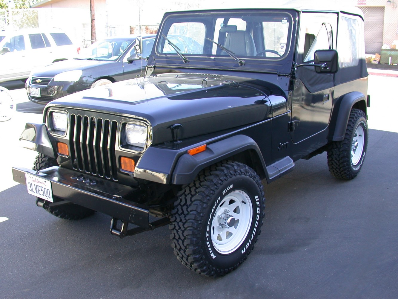 Front view with square headlights and off-road tires