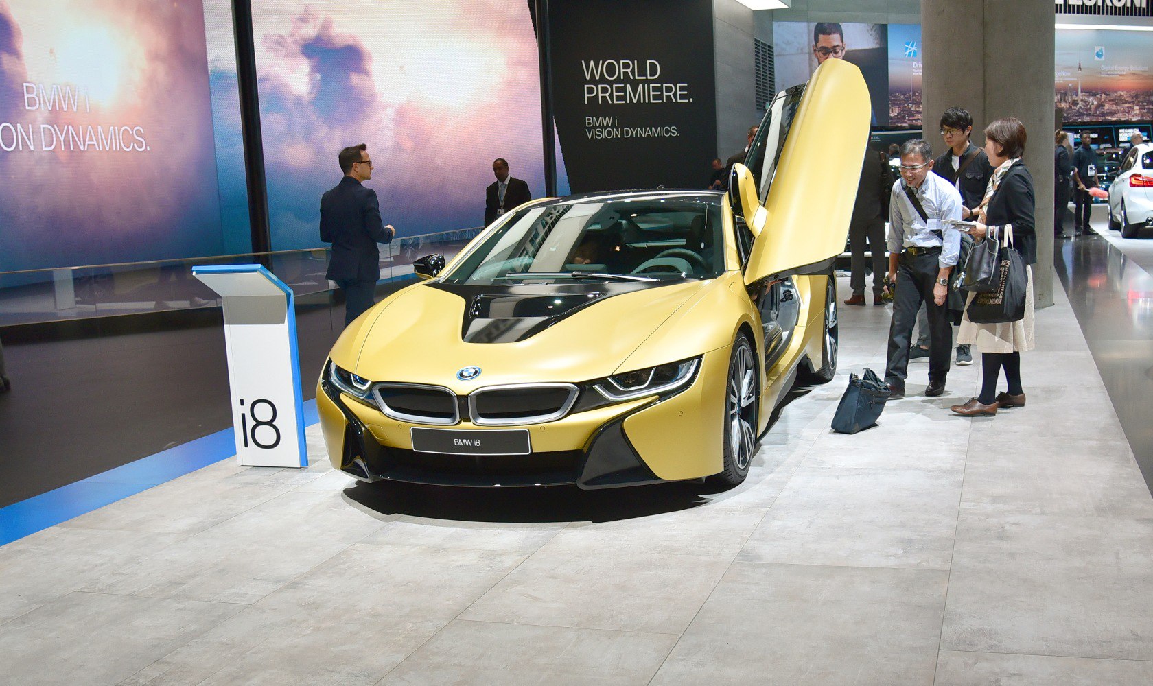 Futuristic sports car with butterfly doors open in exhibition