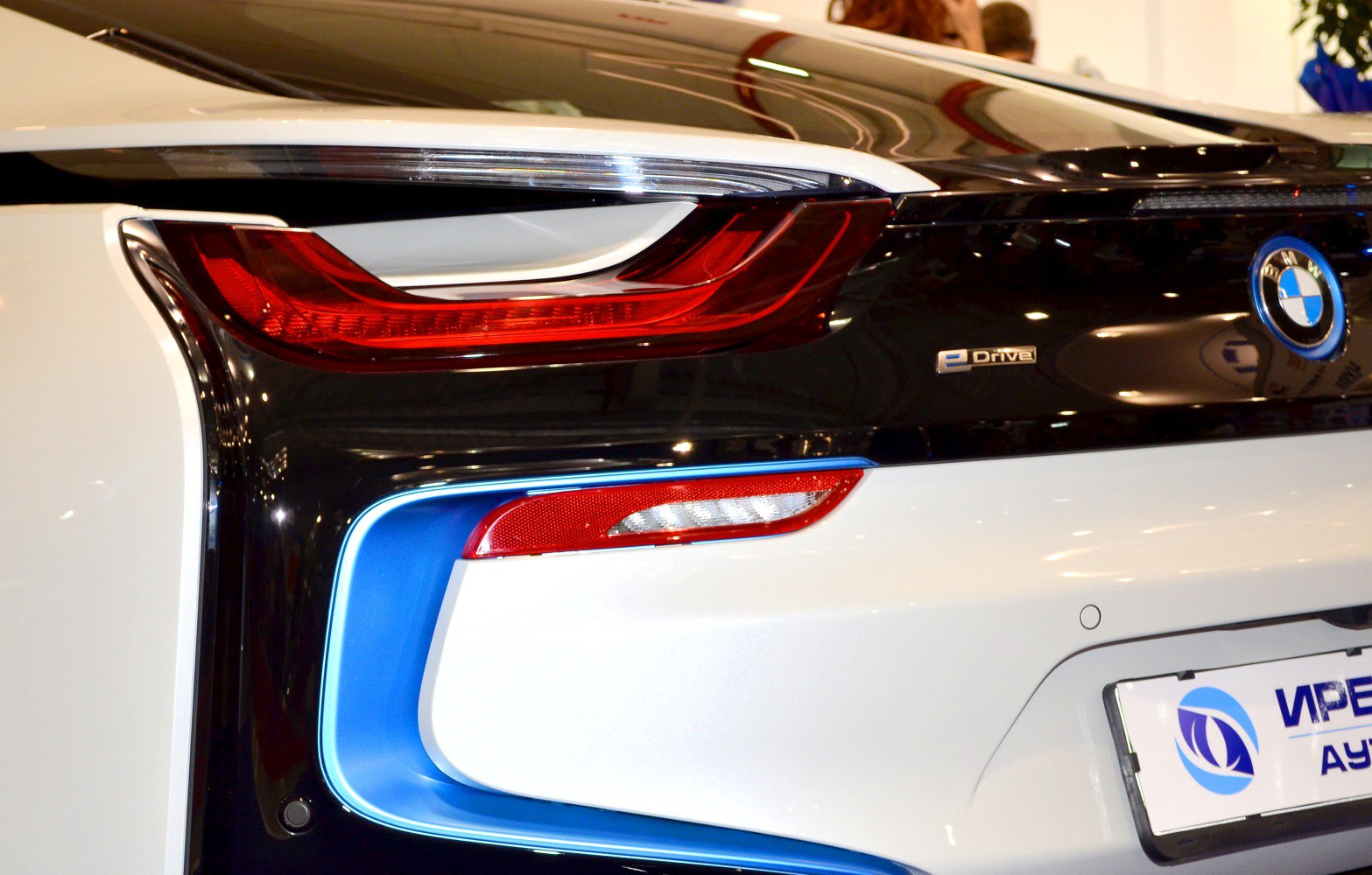 Rear light and eDrive badge with blue trim on a futuristic vehicle's back end.
