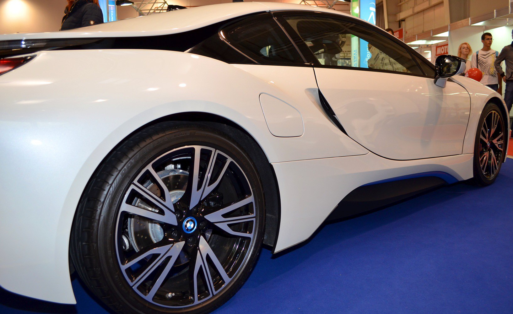 Rear side of a futuristic sports coupe with distinctive alloy wheel