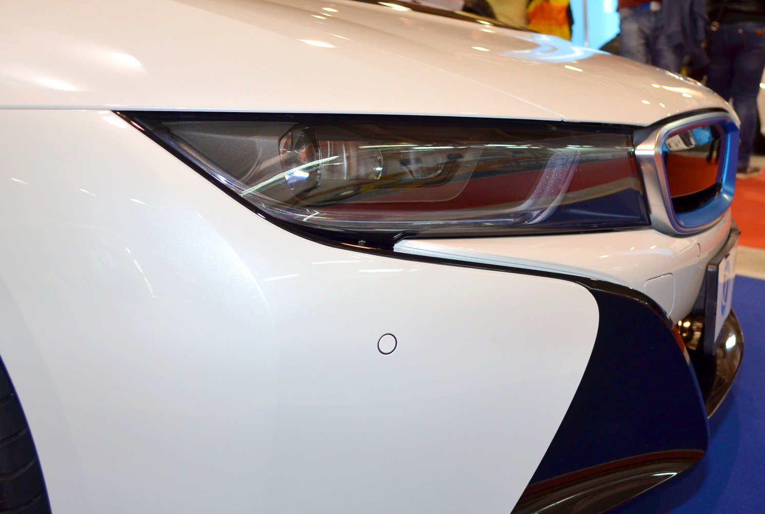 Close-up on front headlight and grille section with sleek aerodynamic design