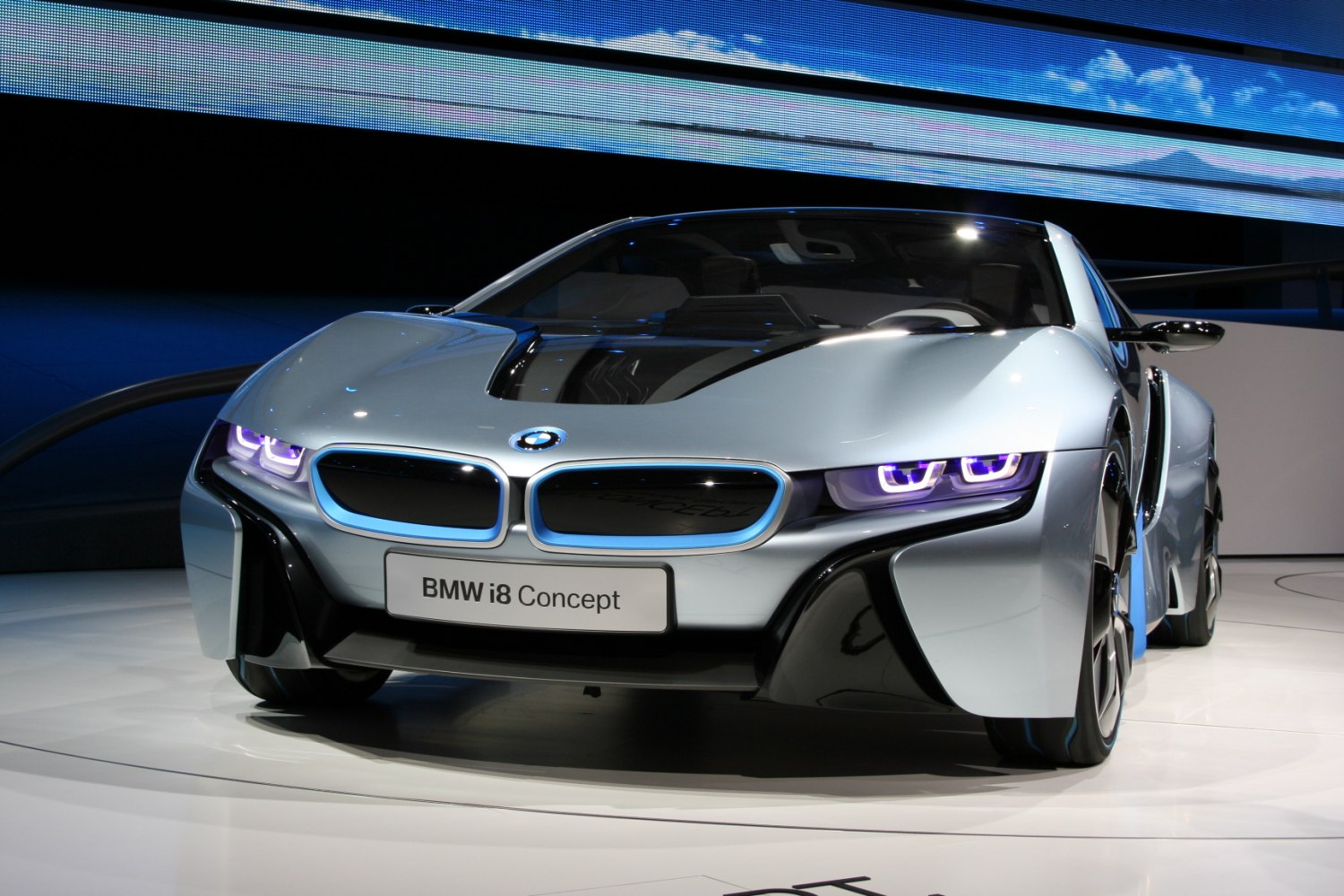 Front view of futuristic concept car with illuminated headlights