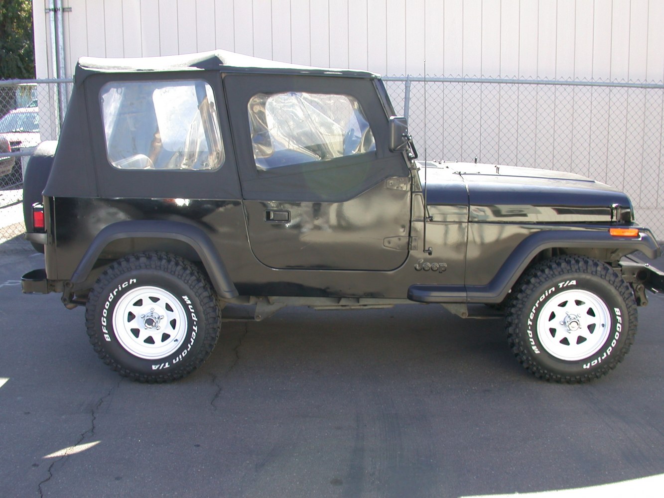 Black Jeep SUV with soft top and off-road BFGoodrich tires