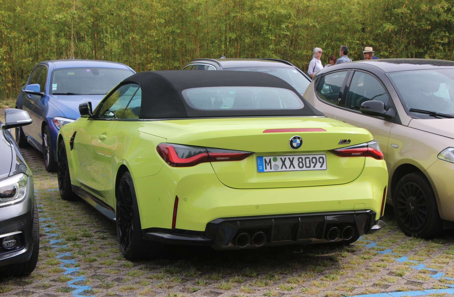 Rear view of a convertible with quad exhaust and black soft top