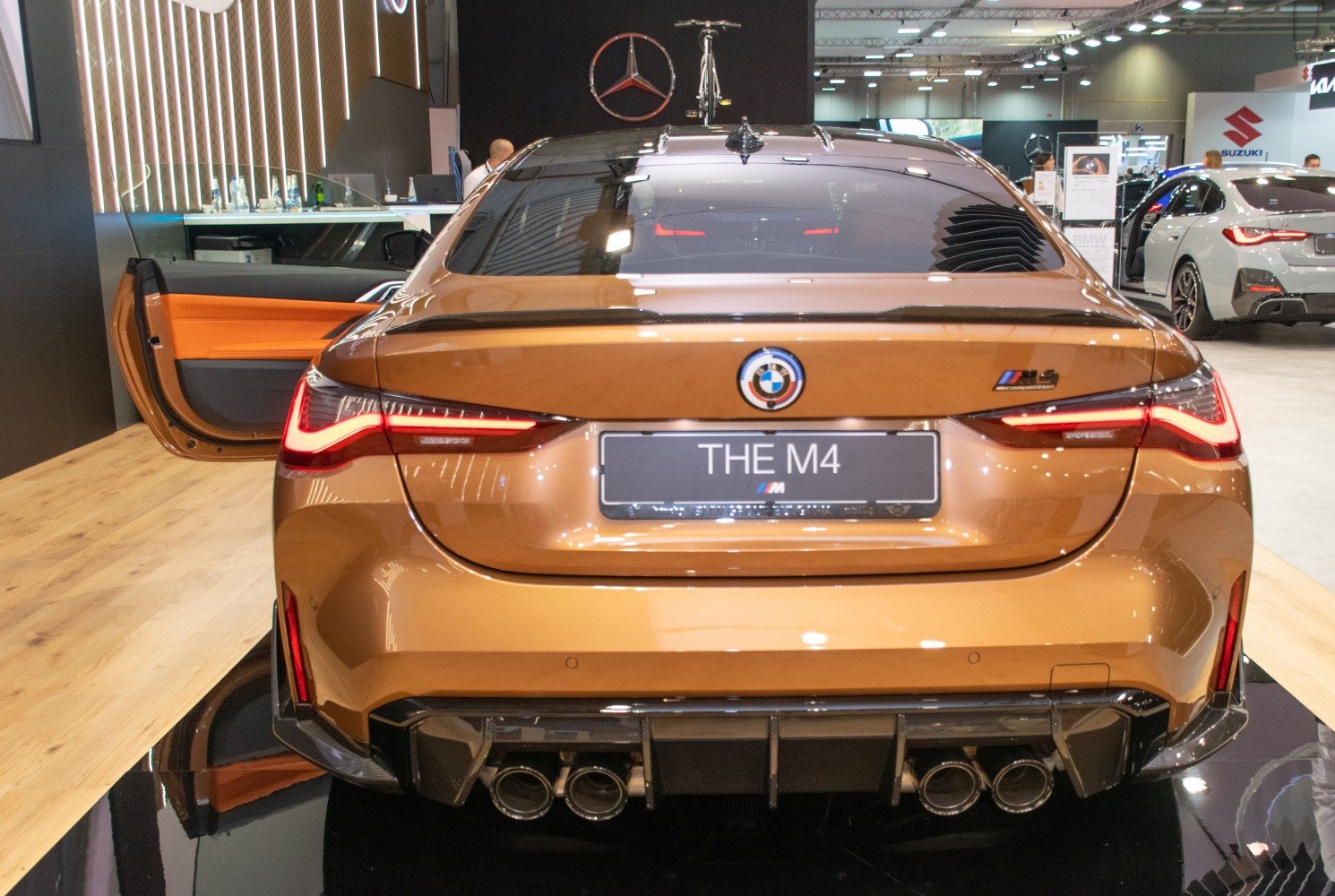 Rear view showing quad exhaust, active spoiler, and sporty taillights