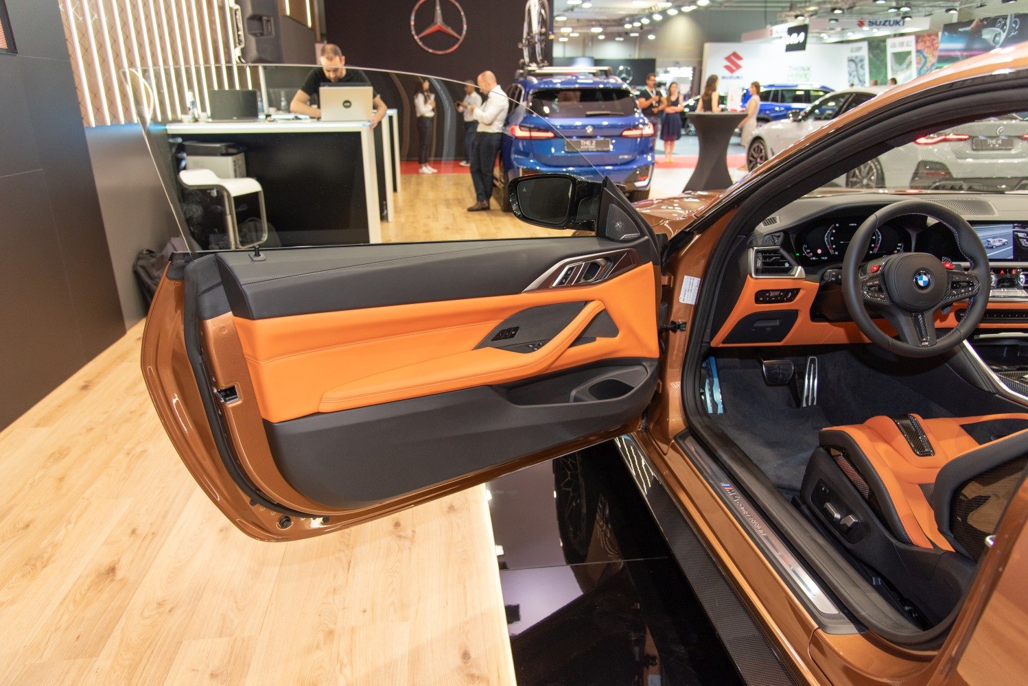 Open door panel and interior dashboard with steering wheel in luxury car.