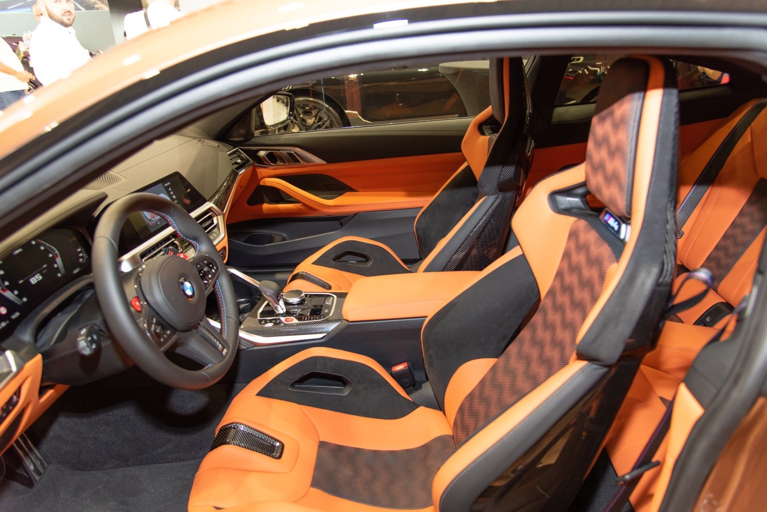 Orange and black racing-style seats with modern sporty interior
