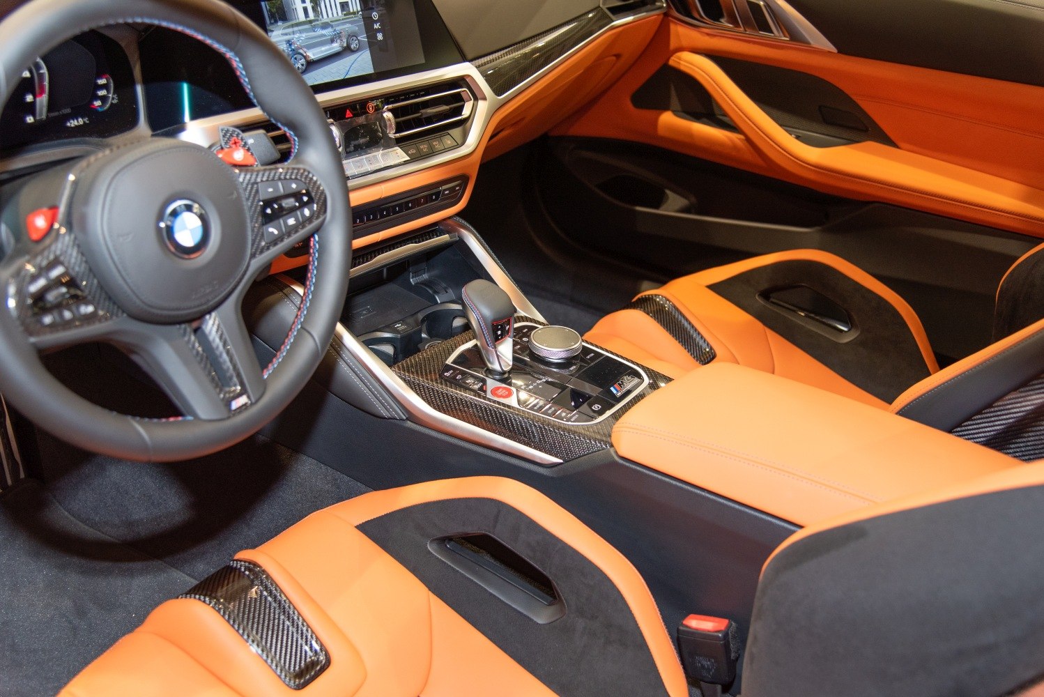Carbon fiber interior accents with orange leather seats and detailed control panel
