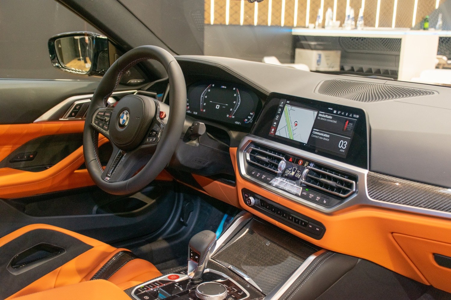 Luxury sports car interior with digital displays and orange upholstery
