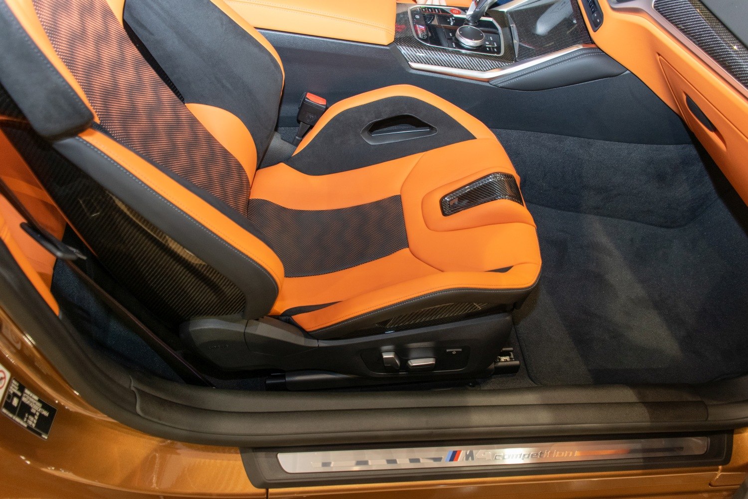 Sport seat with orange-black upholstery and carbon fiber details