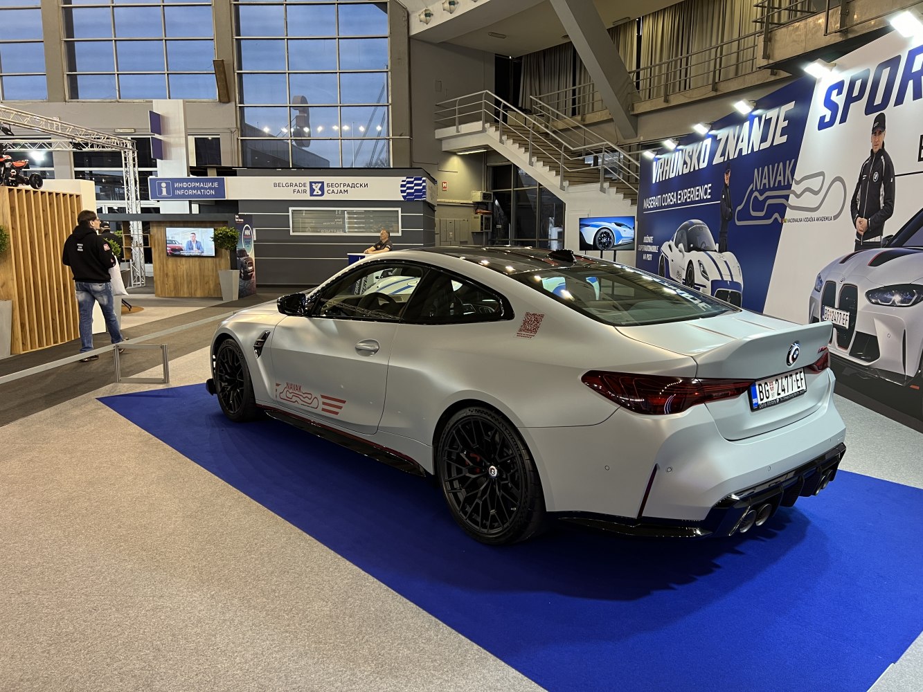 Matte white rear side profile with black rims and quad exhausts