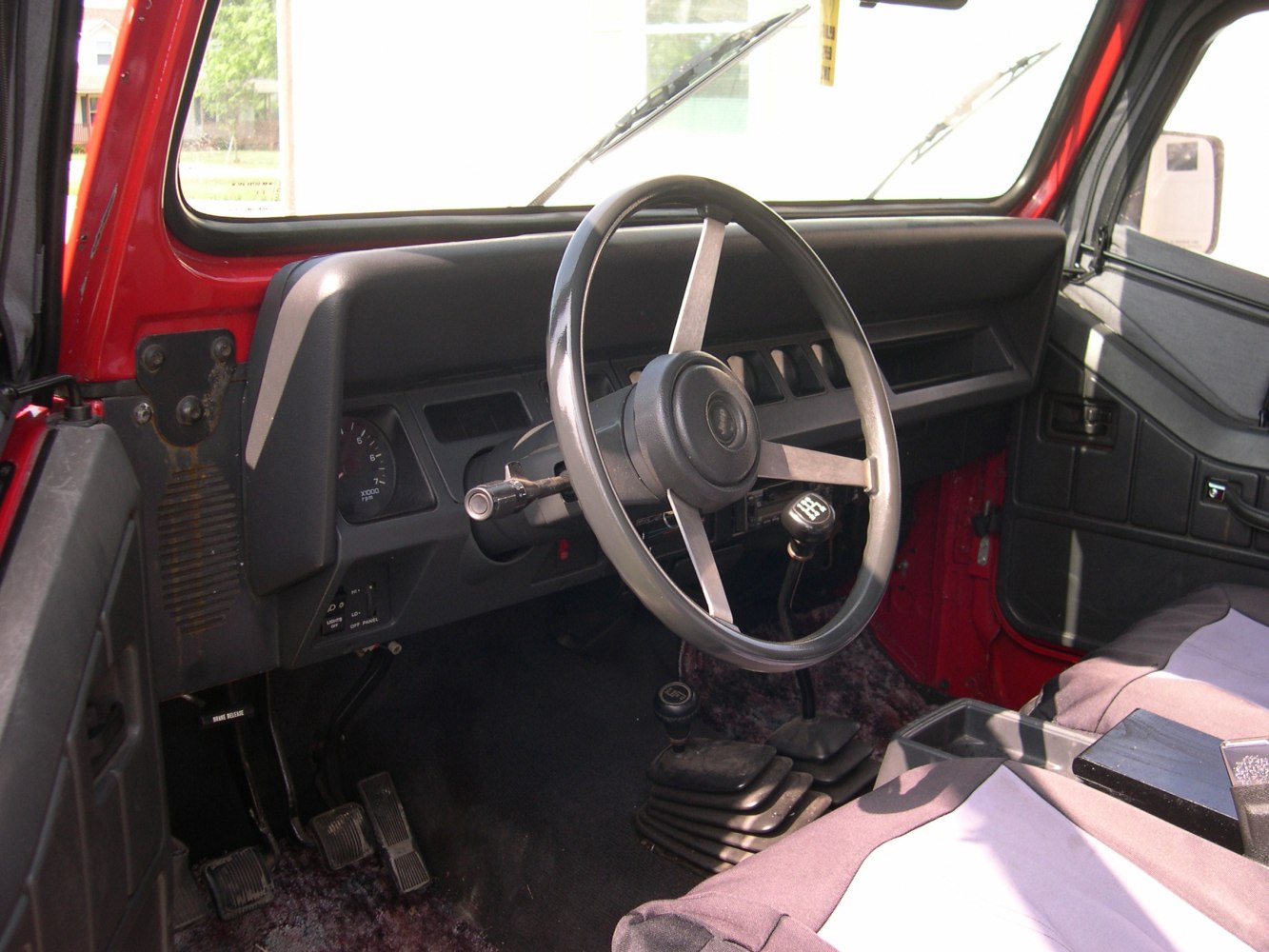 Steering wheel, manual gear shifters, and dashboard inside vehicle
