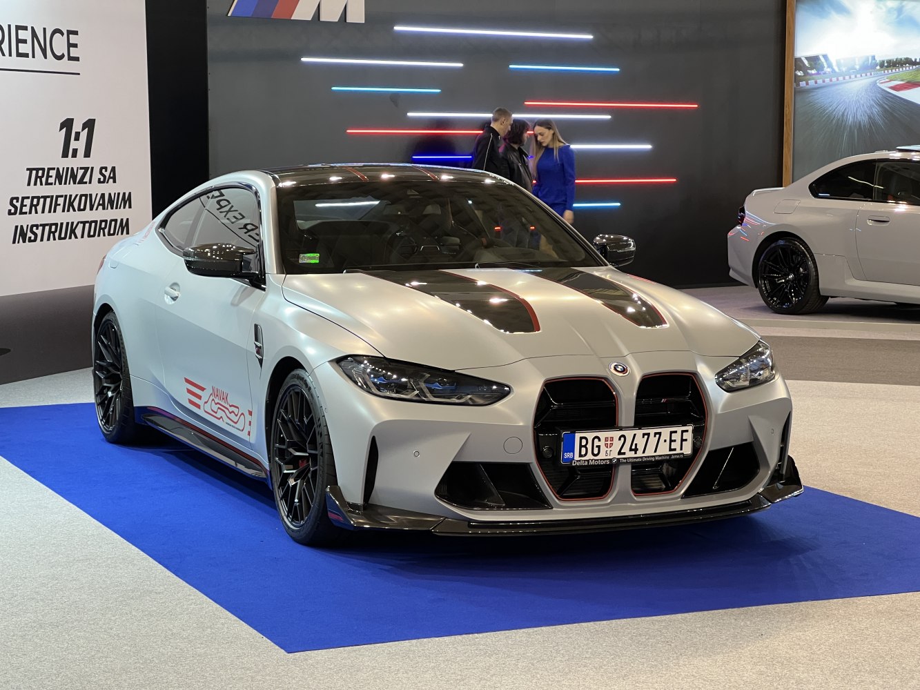Aggressive front grille, sporty coupe with black hood vents and performance wheels