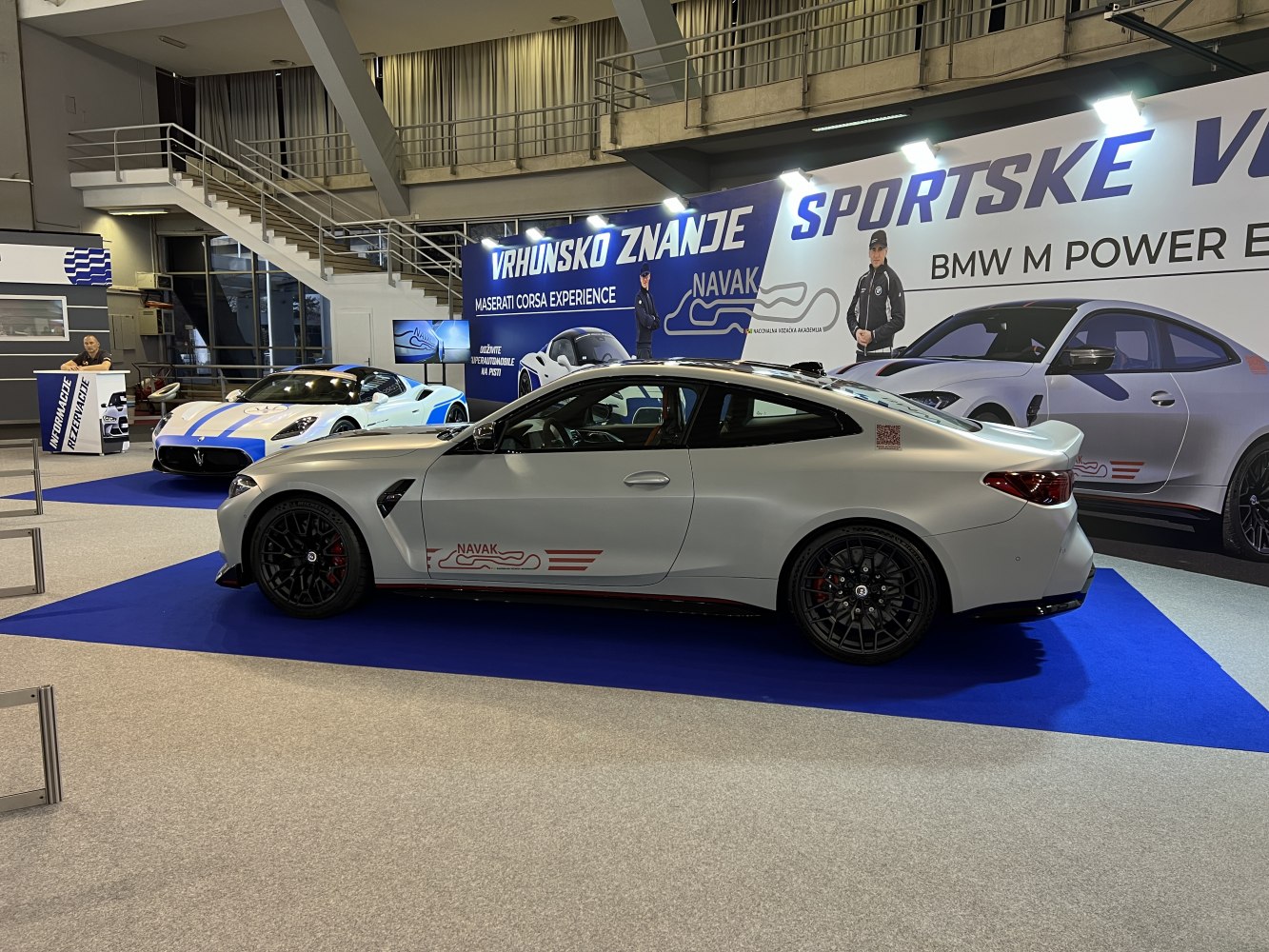 Side view of a coupe with black multi-spoke wheels and aerodynamic body kit