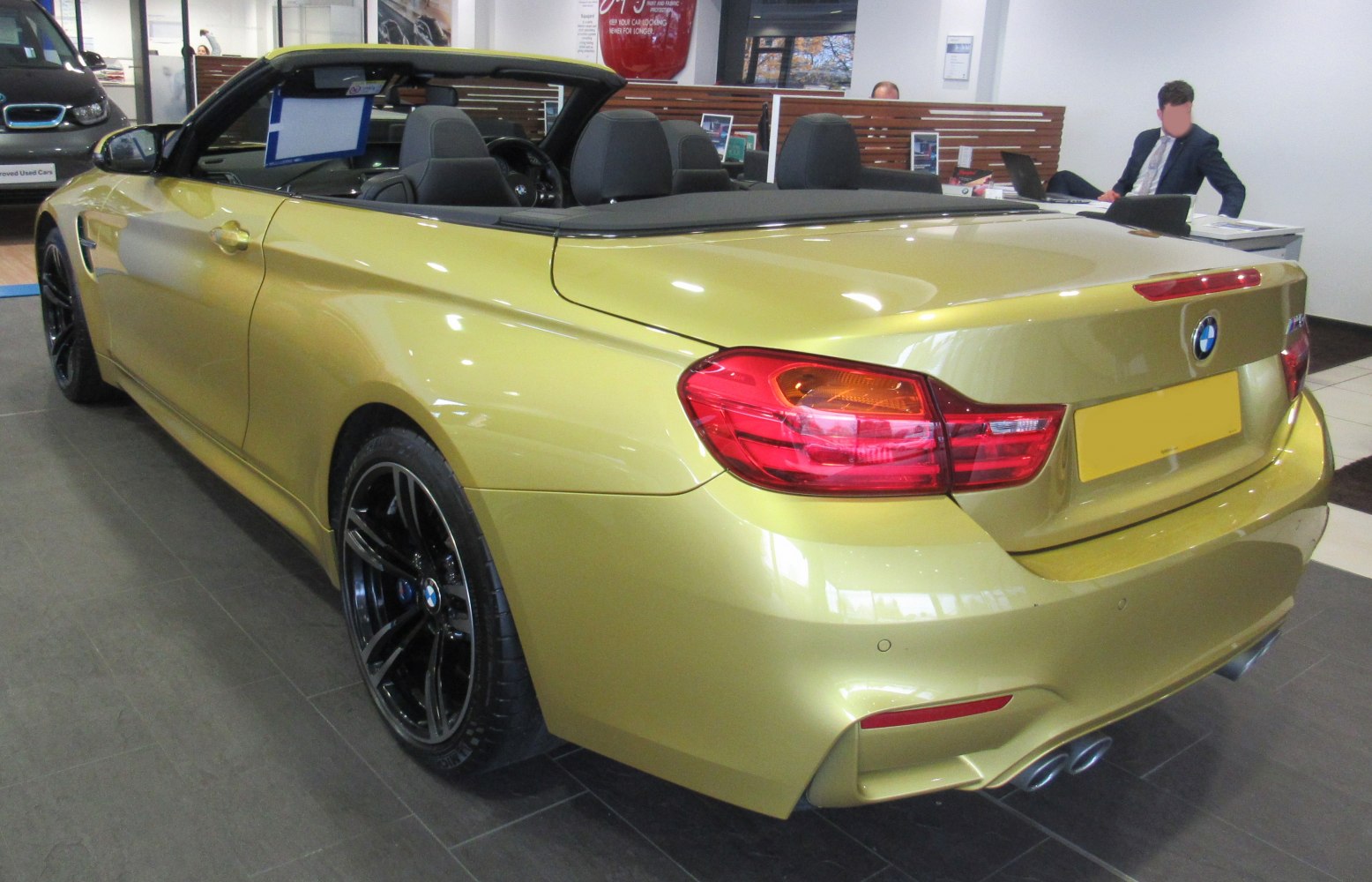 Rear view of sports convertible with quad exhaust and black wheels