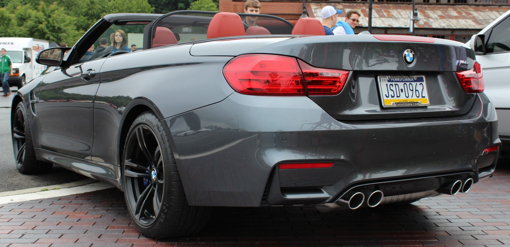 Rear view of convertible with quad exhaust and red leather seats