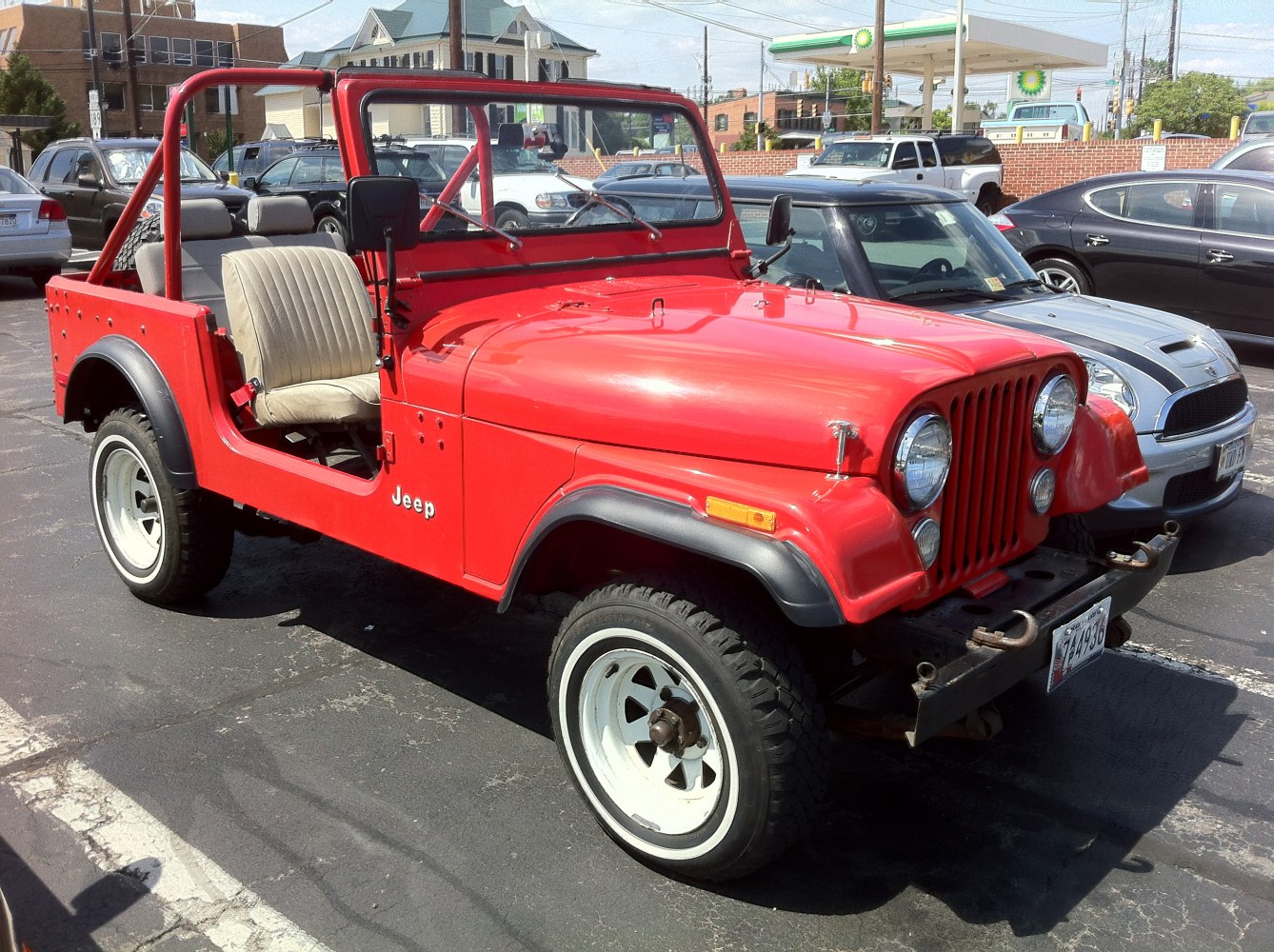 Red open-top off-road vehicle with roll cage and rugged tires