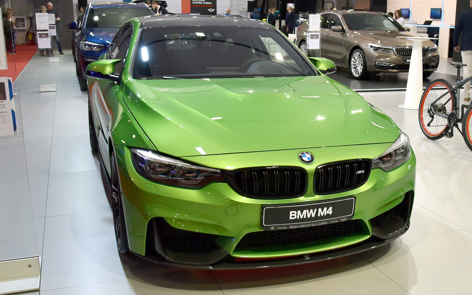 Green sports coupe with sleek aggressive front fascia and kidney grille