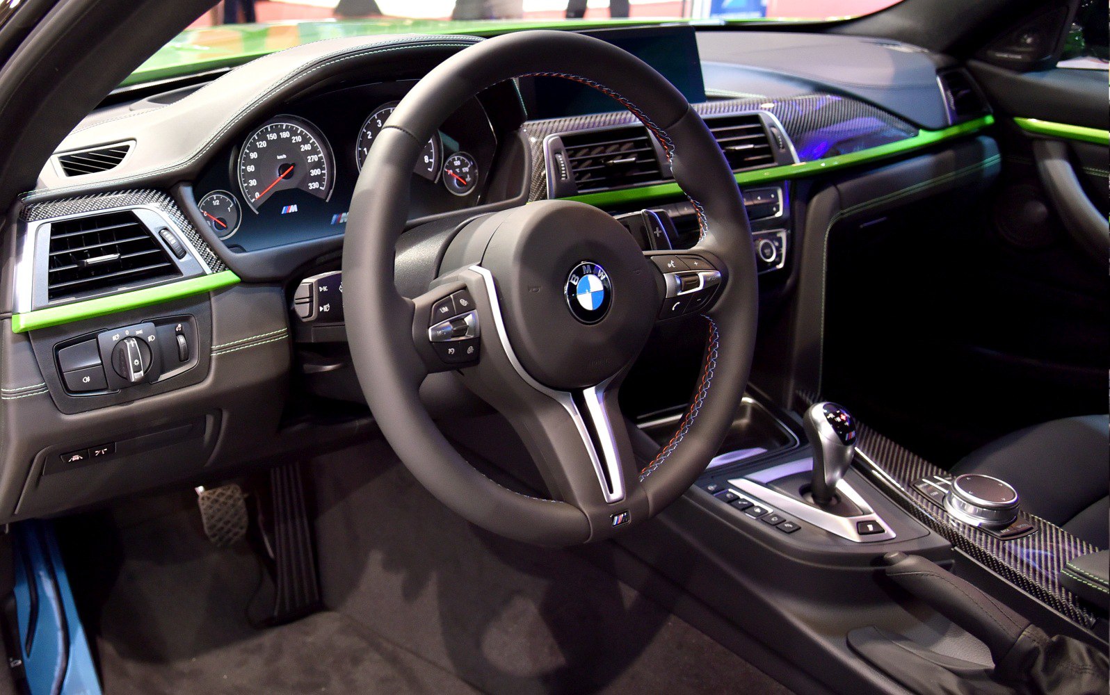 Sporty steering wheel and carbon fiber dashboard trim in car interior