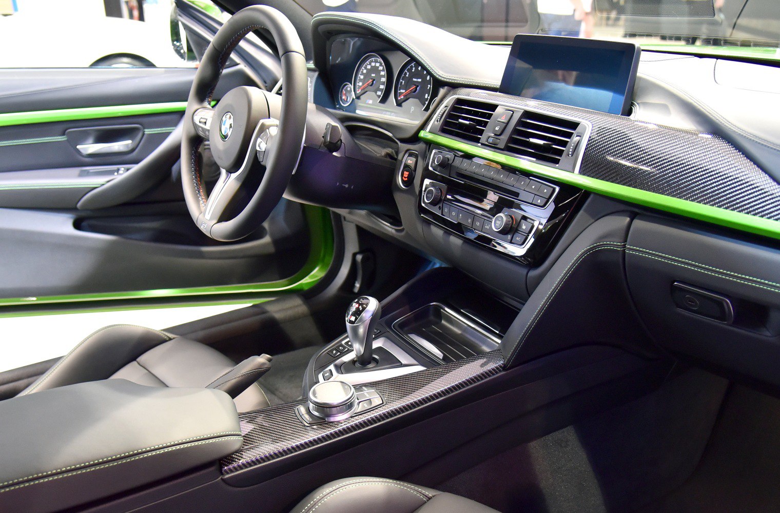 Sporty dashboard and steering wheel with carbon fiber accents and digital display