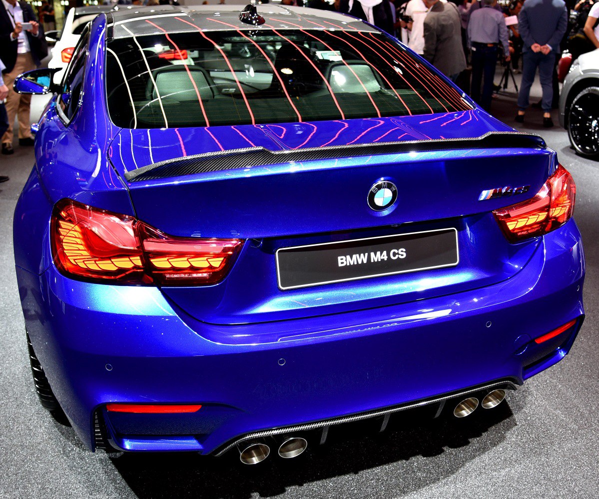 Rear view with distinctive taillights, carbon fiber spoiler, quad exhausts