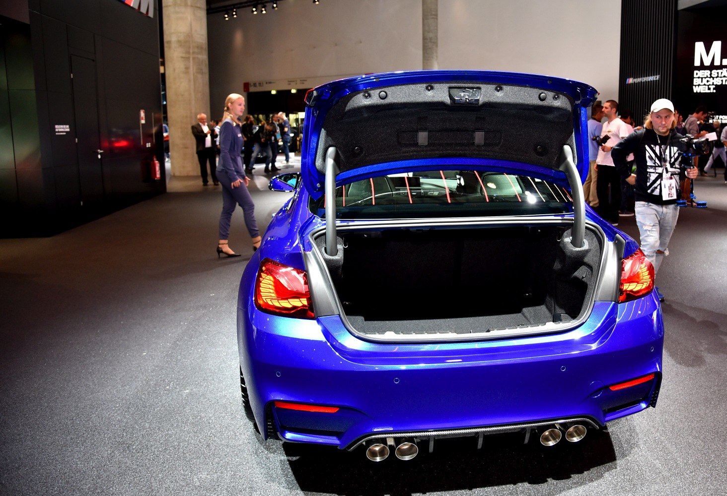Open trunk and rear view with taillights and quad exhausts