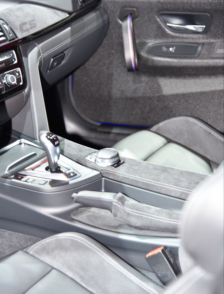 Close-up of gear shift, control knob, and center console in car interior