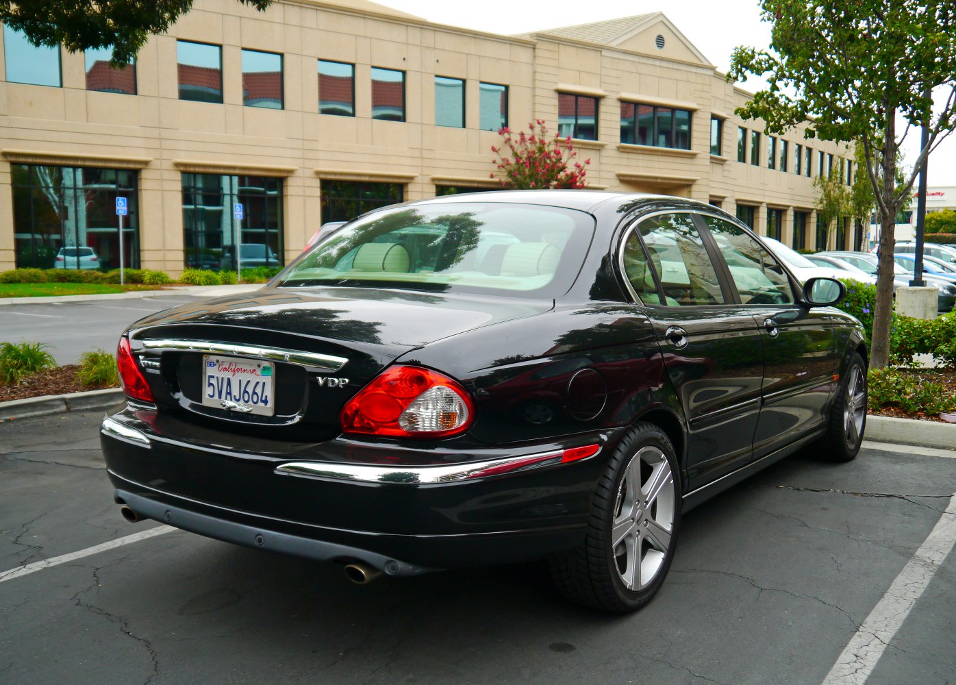 Rear view of sedan with dual exhaust and chrome trim