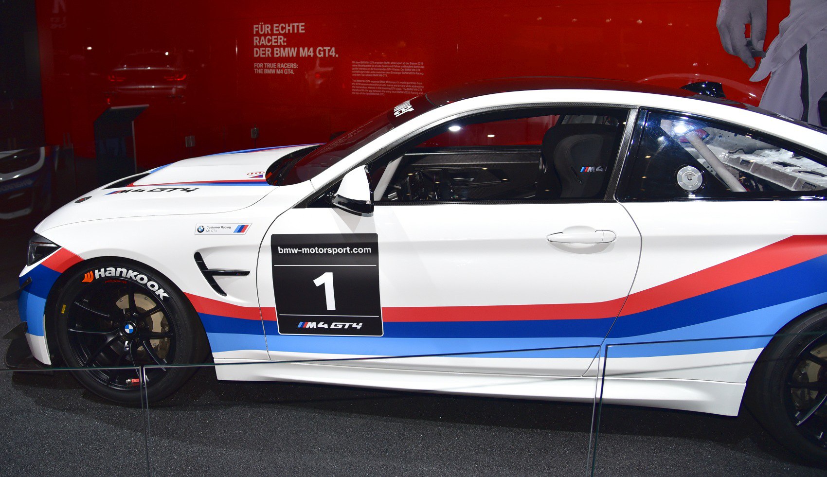 Side profile of BMW M4 GT4 race car with motorsport livery and racing setup