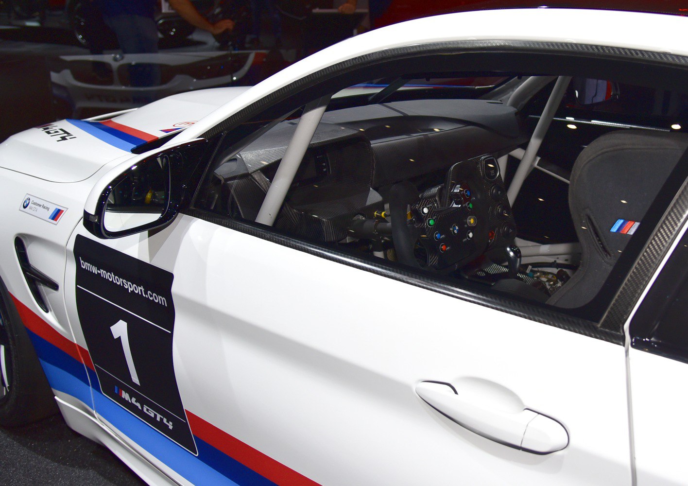 Race car steering wheel and roll cage interior with exterior race livery