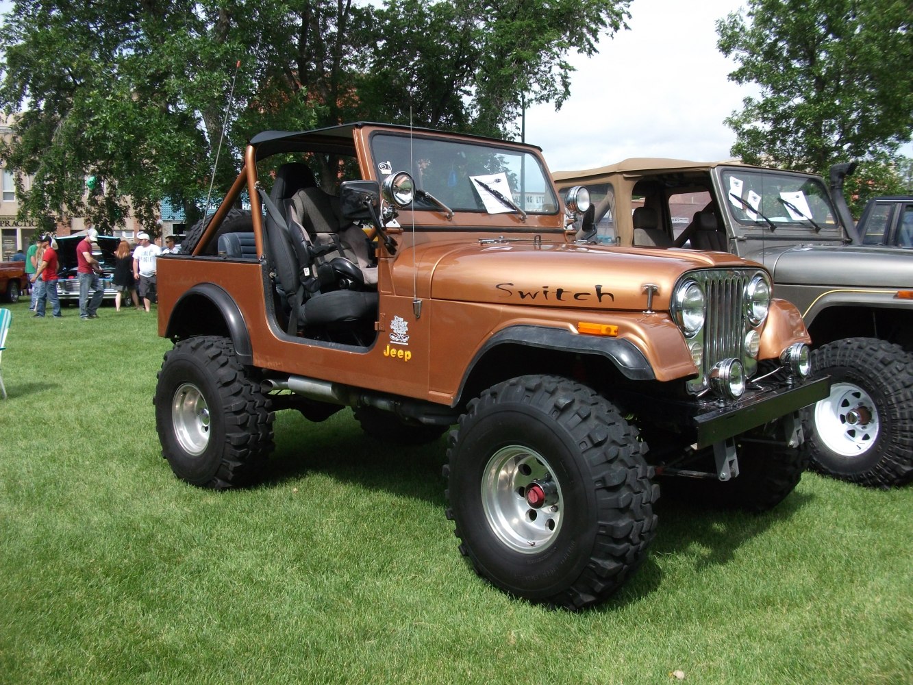 Lifted off-road vehicle with open top and roll cage