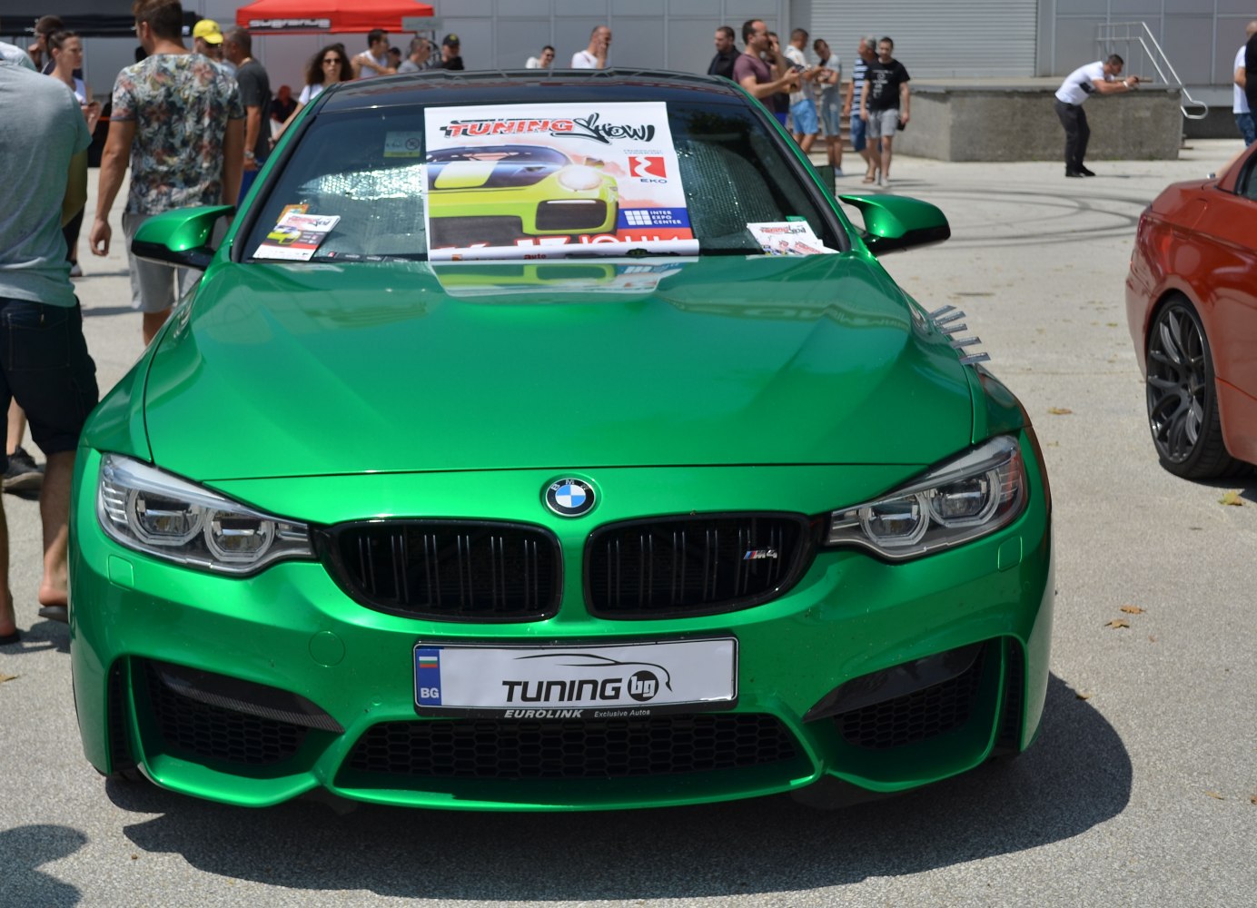 Front view with green paint, aggressive headlights, and kidney grille