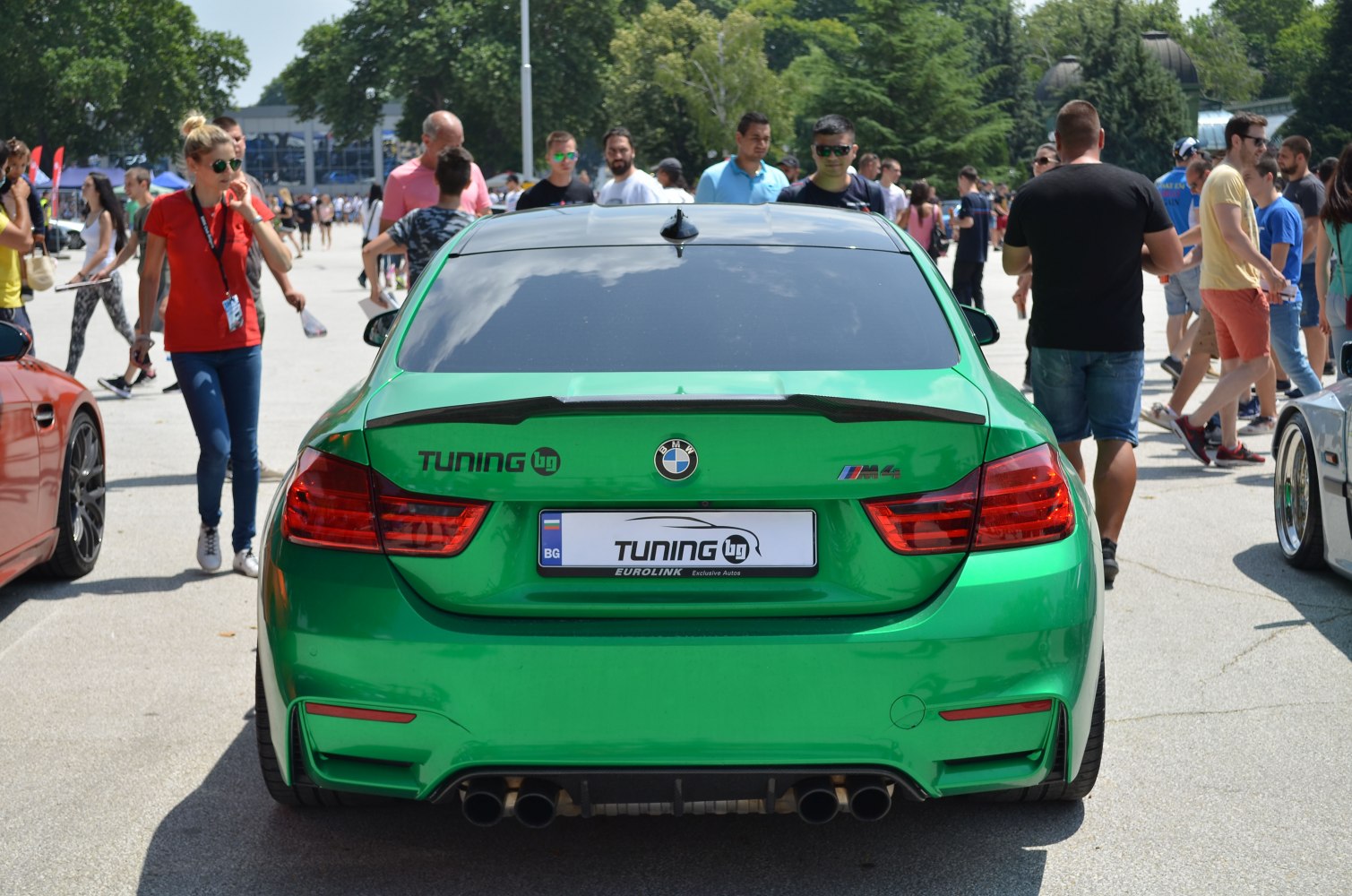 Rear of a BMW M4 with quad exhaust and rear spoiler
