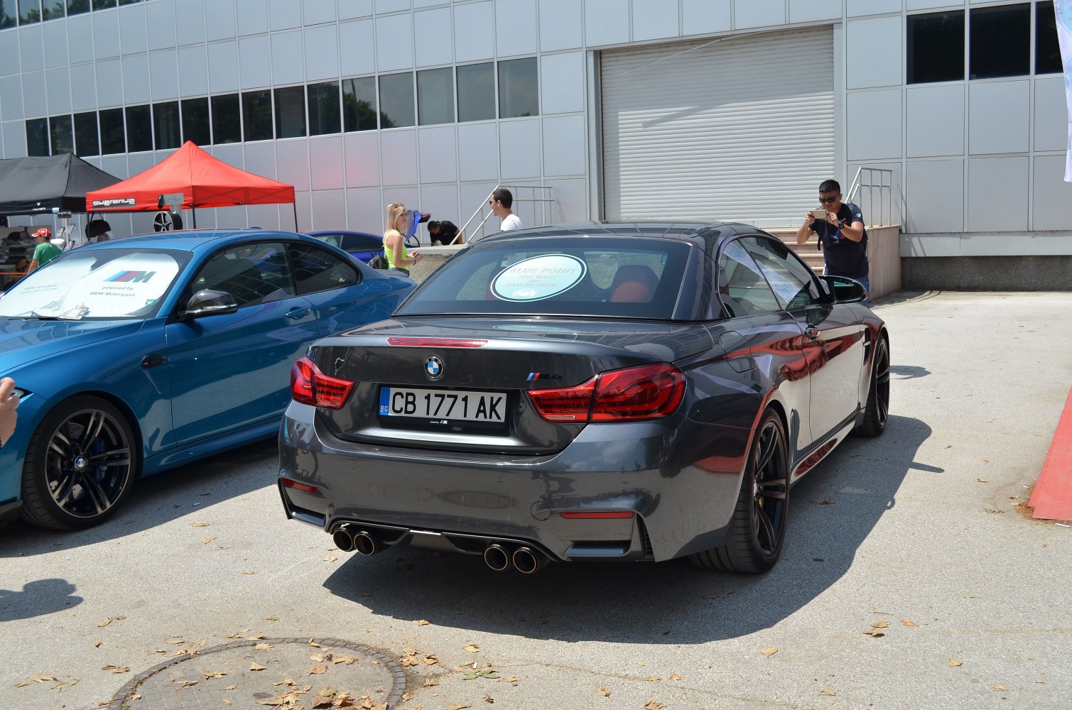 Rear view of a sporty convertible with quad exhaust pipes