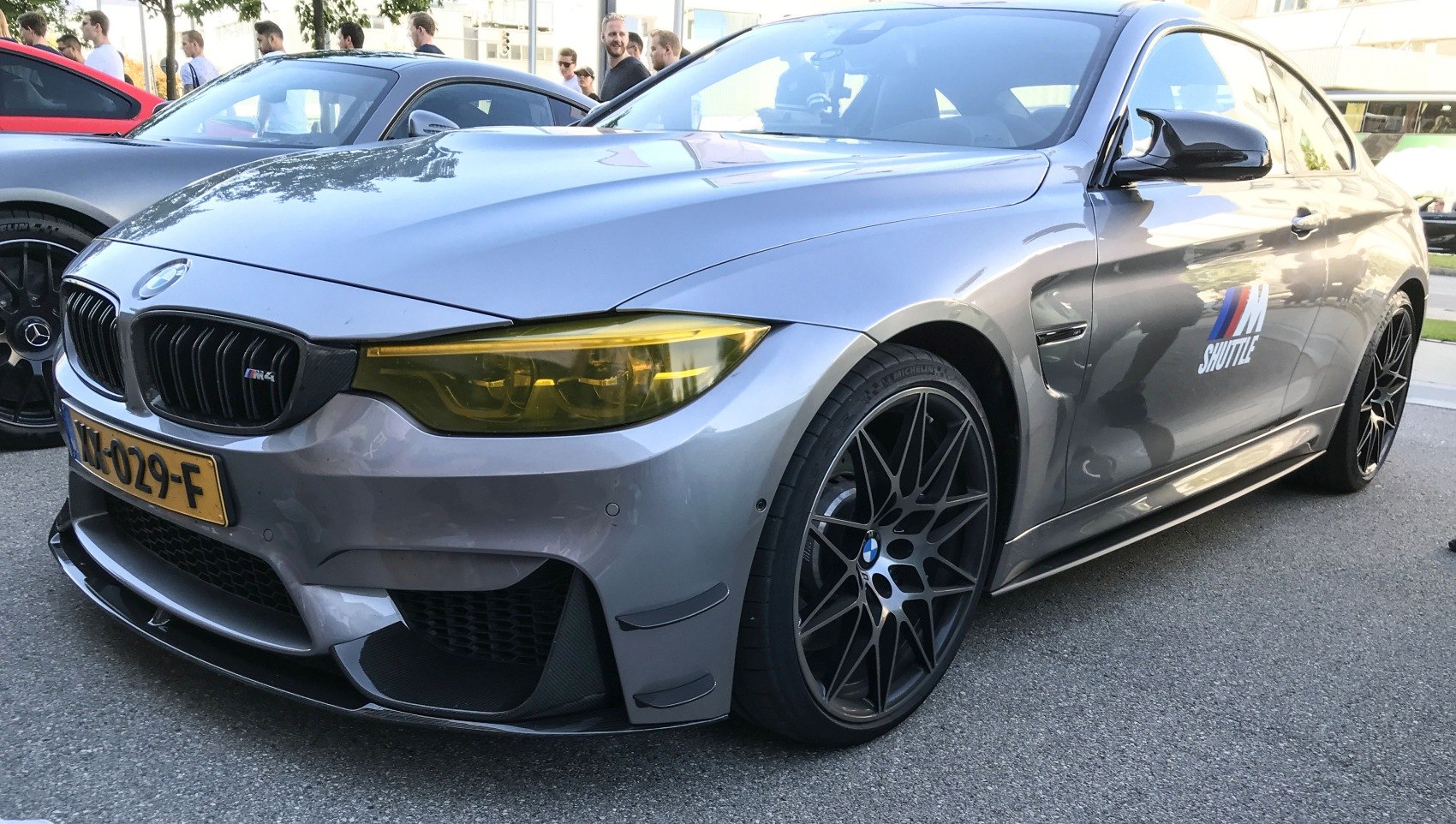 Front view with yellow headlights and black multi-spoke wheels
