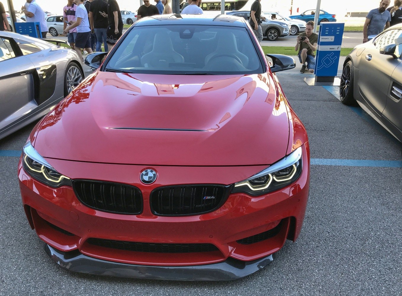 Red sports coupe front with aggressive grille and distinctive headlights