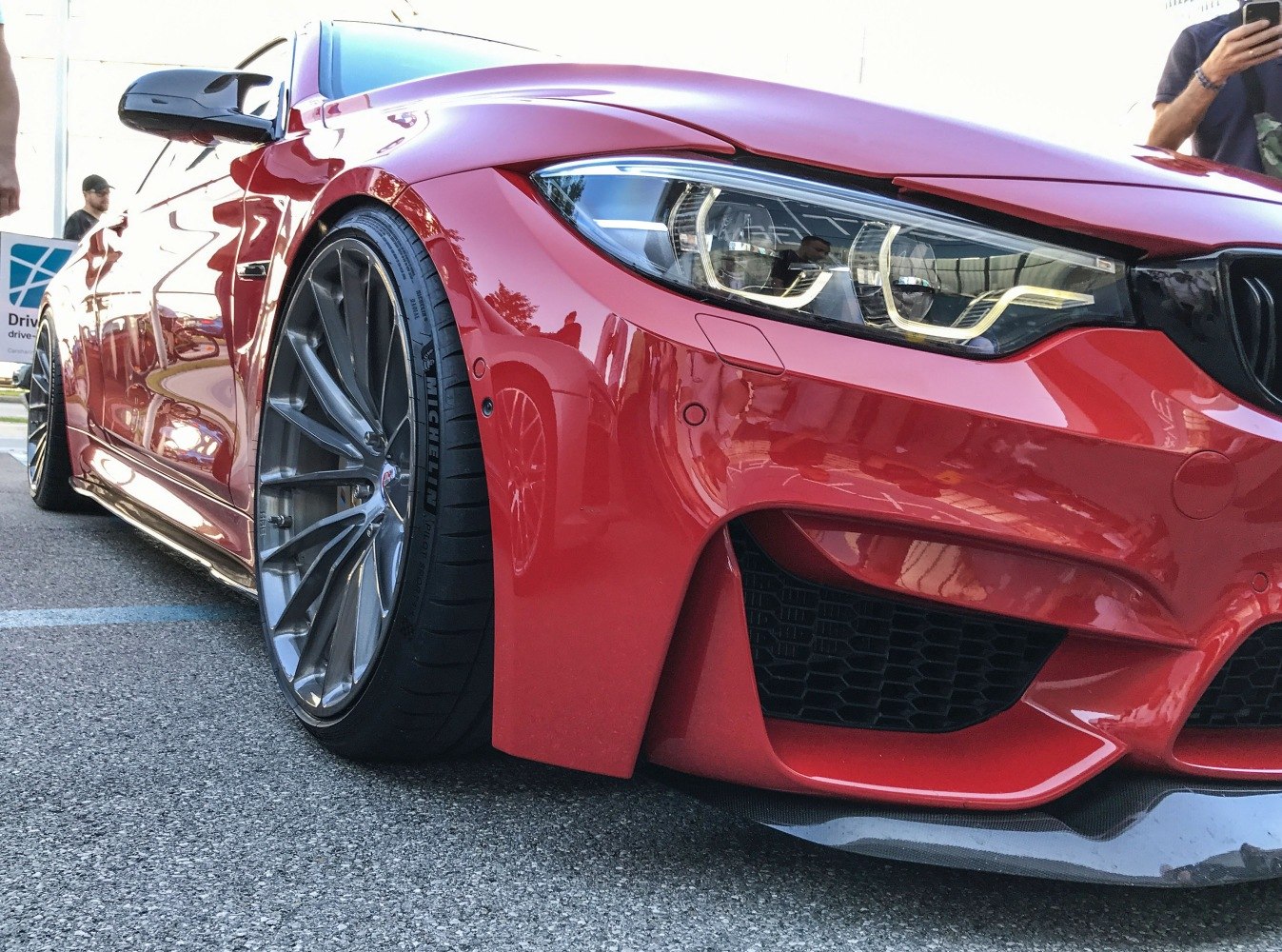 Close-up of front bumper, LED headlight, and alloy wheel