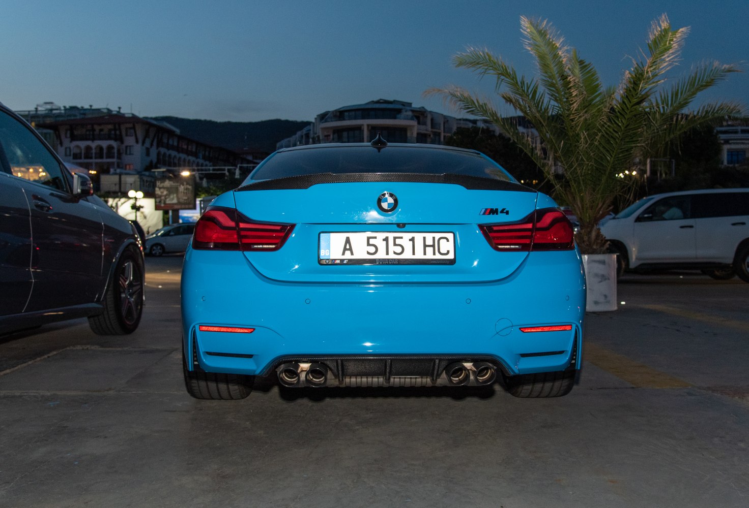 Rear view with quad exhaust pipes and carbon fiber rear spoiler