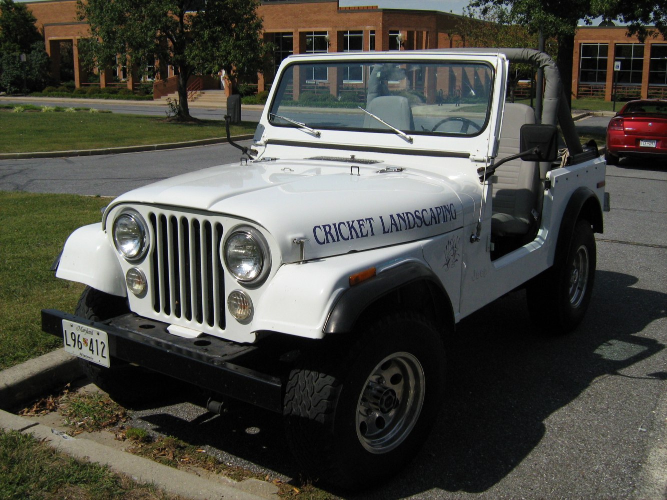 Open-top vehicle with round headlights and classic grille