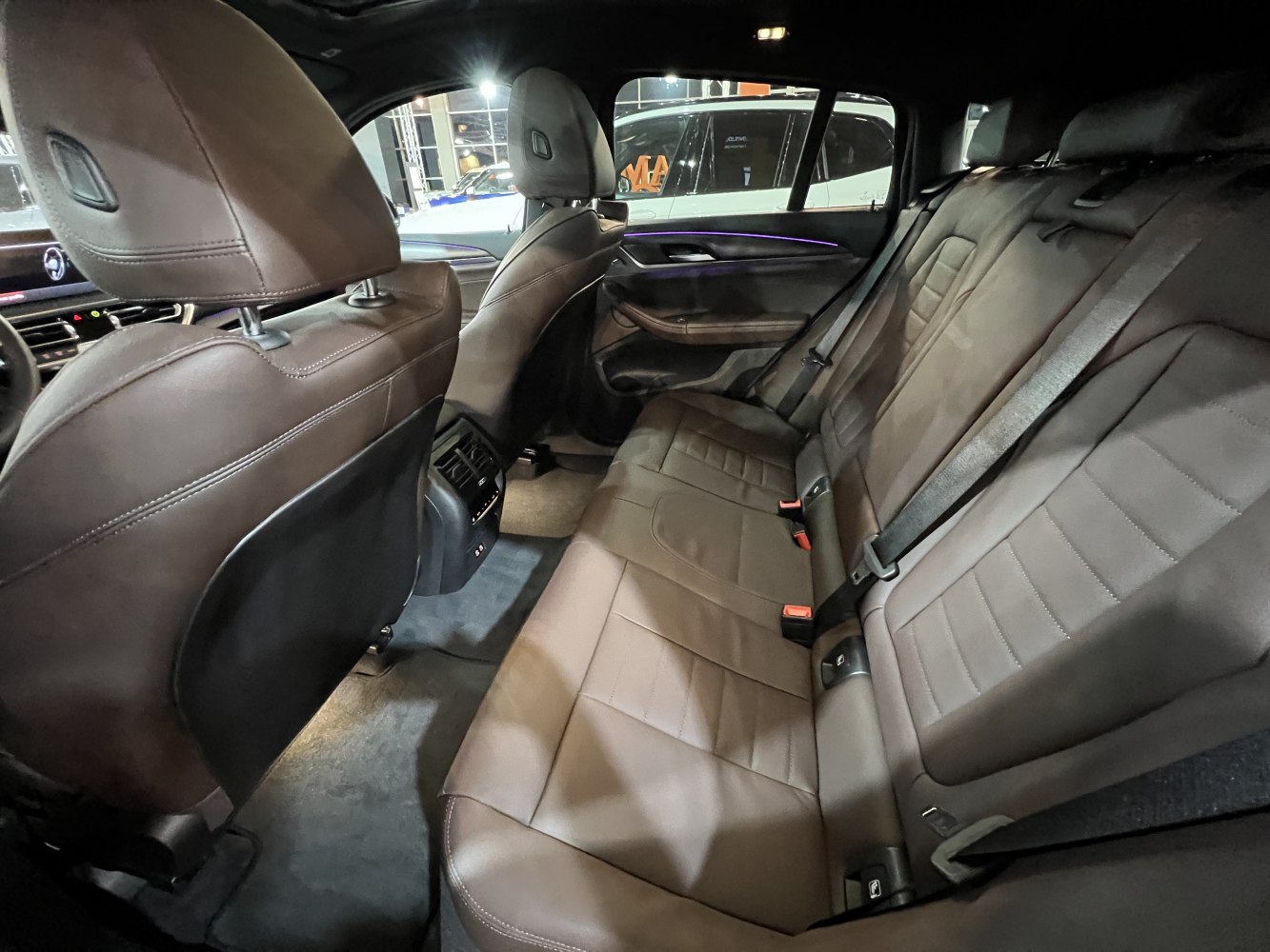 Brown leather rear seats with spacious seating and ambient lighting
