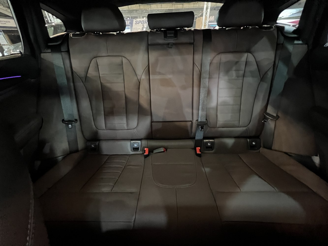 Leather rear seats with seat belts and integrated headrests in a mid-size SUV interior